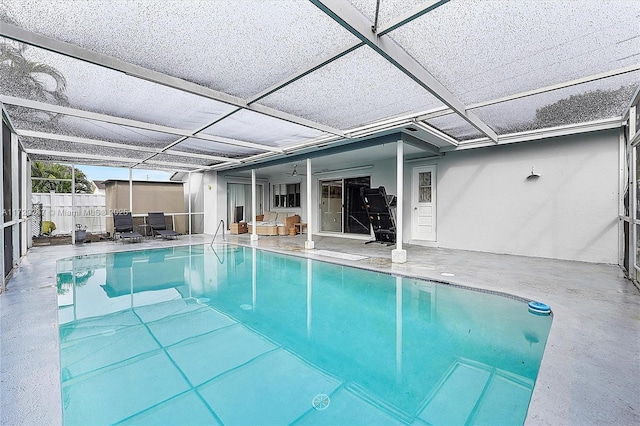 view of swimming pool featuring a patio area, a lanai, and ceiling fan