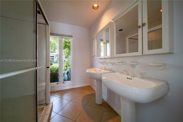 bathroom featuring double sink and tile patterned flooring