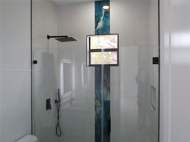 bathroom with a shower with door and toilet