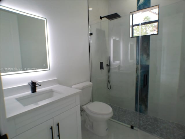 bathroom featuring toilet, an enclosed shower, and vanity