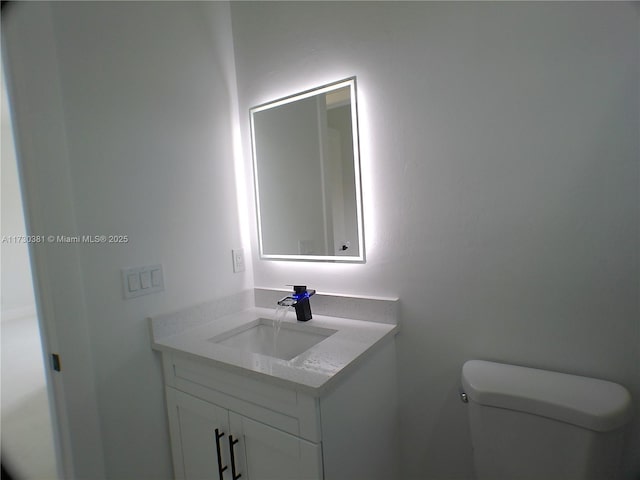 bathroom featuring toilet and vanity