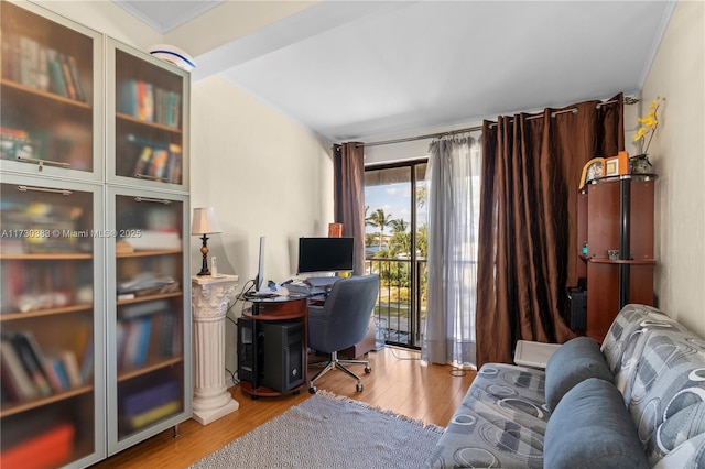 office area with ornamental molding and light hardwood / wood-style floors