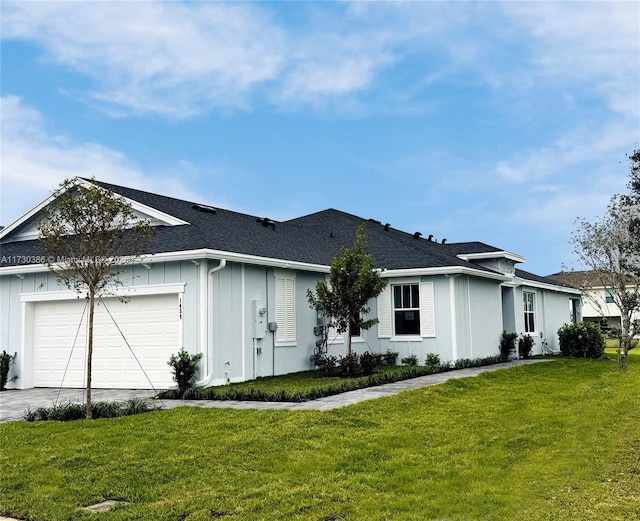 ranch-style house featuring a front yard and a garage