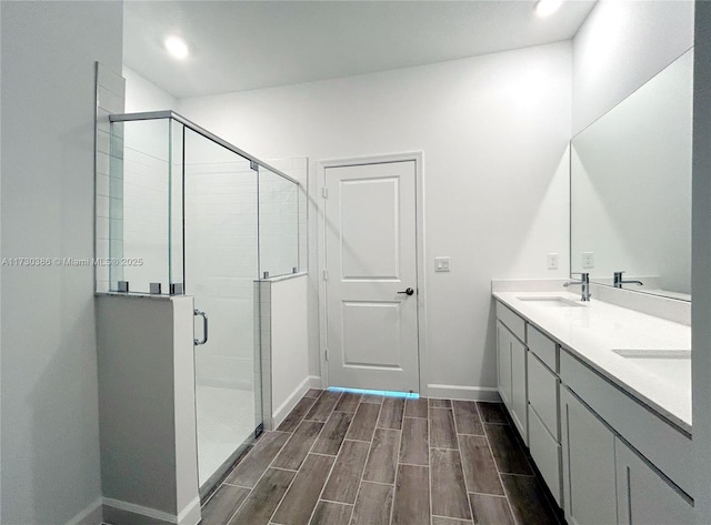 bathroom with vanity and a shower with shower door