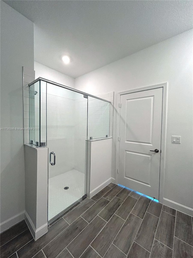 bathroom with a shower with shower door