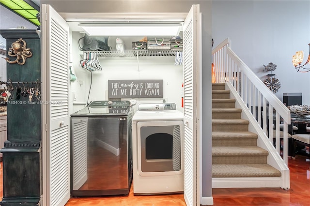 washroom featuring washer and dryer and wood-type flooring