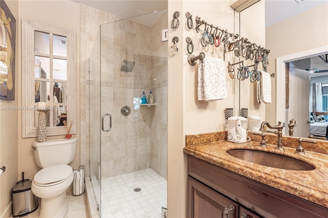 bathroom featuring a shower with door, toilet, tile patterned flooring, and vanity