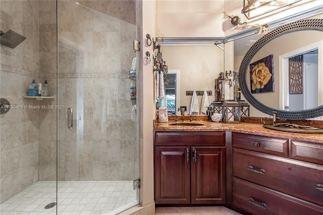 bathroom featuring vanity, walk in shower, and tile patterned flooring