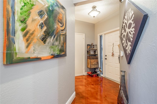 hall with a textured ceiling