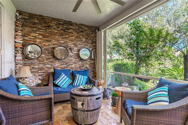 sunroom / solarium featuring ceiling fan