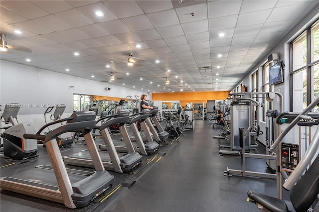 workout area featuring a paneled ceiling and plenty of natural light