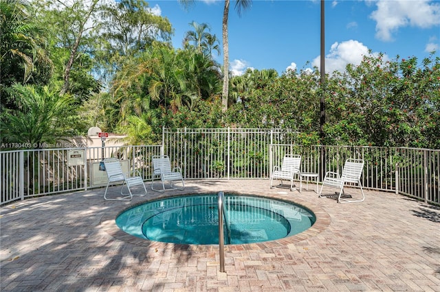 view of pool with a community hot tub and a patio area