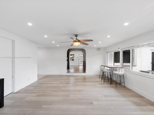 interior space with ceiling fan, a wealth of natural light, and light hardwood / wood-style flooring