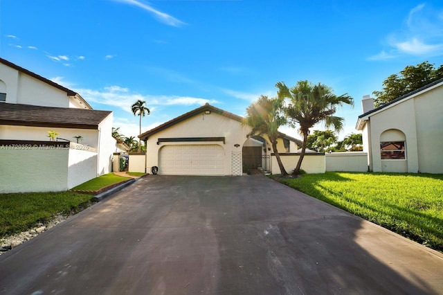 view of front of home featuring a garage and a front lawn