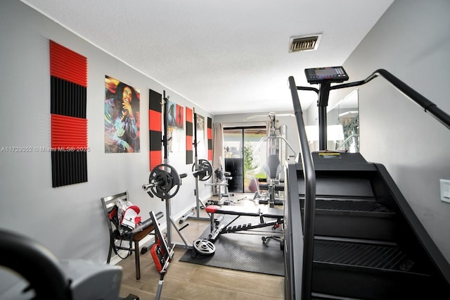 workout room featuring a textured ceiling