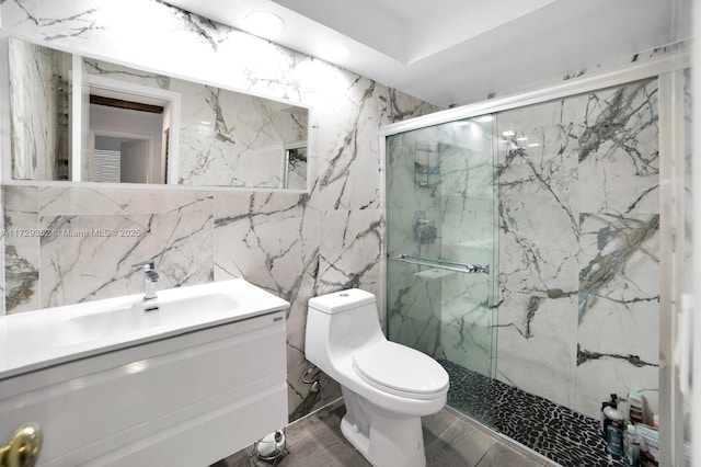 bathroom featuring toilet, vanity, and an enclosed shower