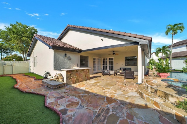 rear view of house featuring ceiling fan, a patio area, french doors, and an outdoor hangout area