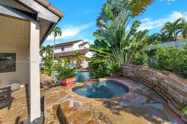 view of pool with an in ground hot tub and a patio