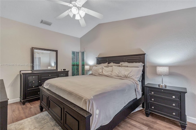 bedroom featuring lofted ceiling, hardwood / wood-style flooring, and ceiling fan