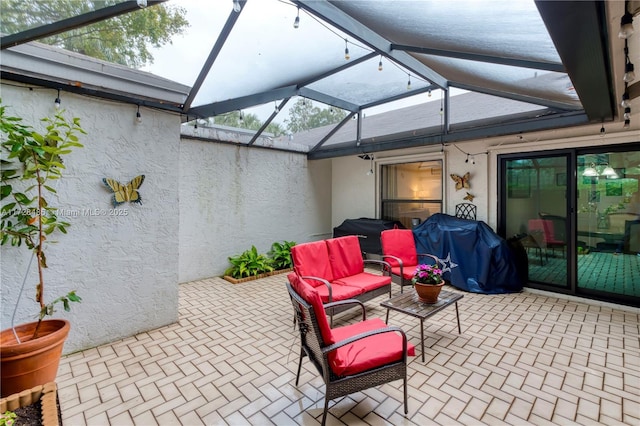 view of patio with glass enclosure