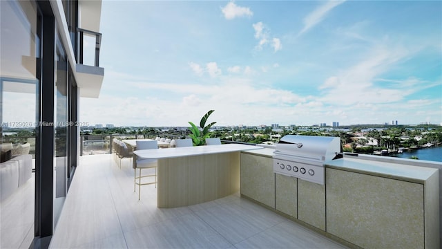 view of patio featuring a balcony, a water view, exterior kitchen, and area for grilling