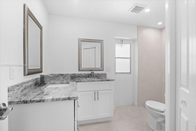 bathroom featuring vanity, toilet, and tile patterned flooring