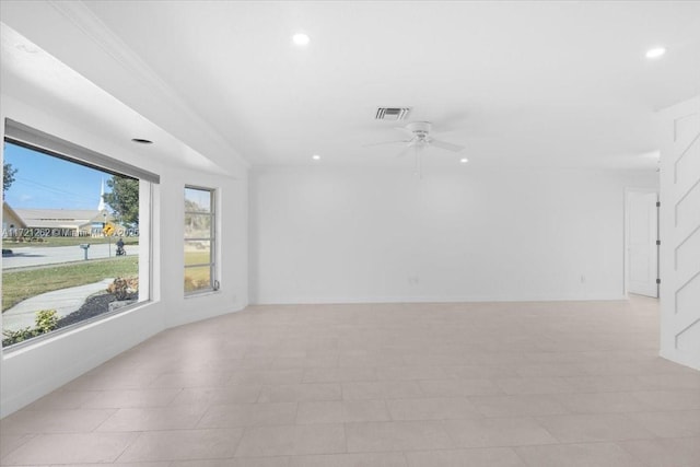 empty room with ceiling fan and crown molding