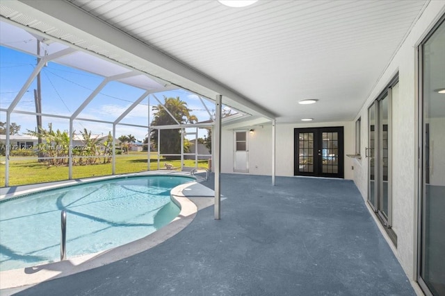 view of swimming pool featuring a patio area, a lanai, a yard, and french doors