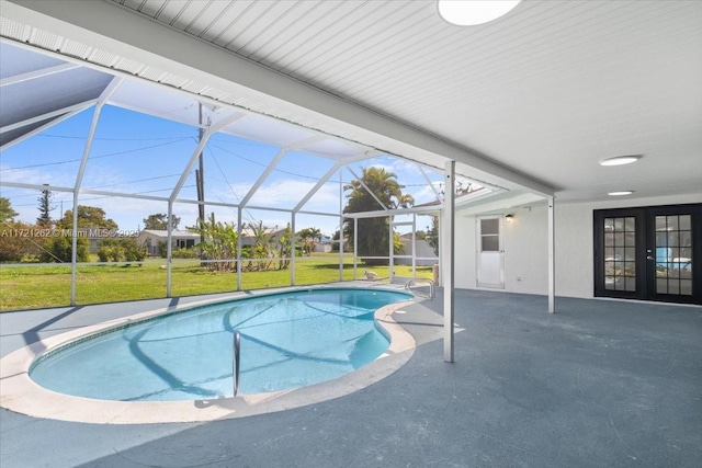 view of swimming pool with glass enclosure, a lawn, french doors, and a patio