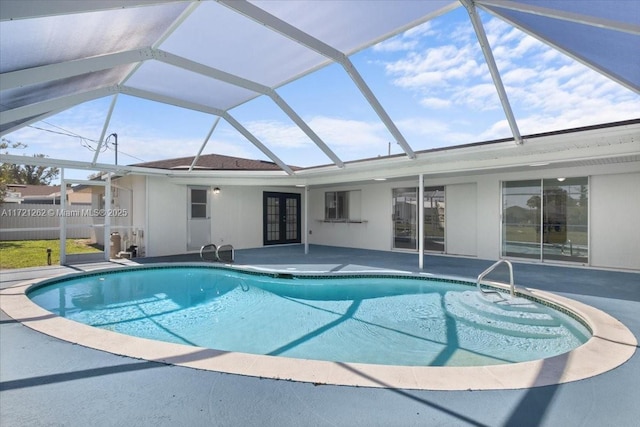 view of pool featuring a patio area, a lanai, and french doors