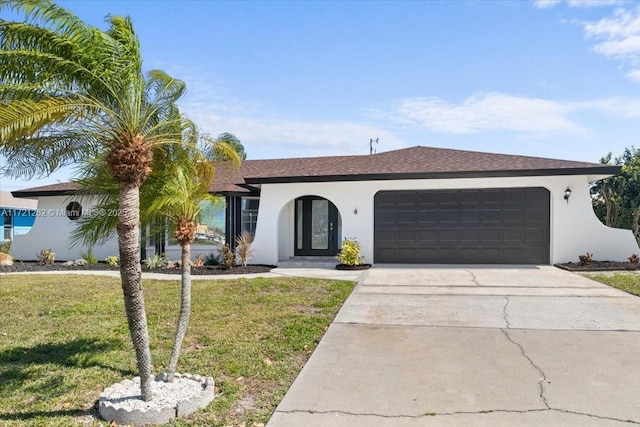 view of front facade featuring a garage and a front lawn