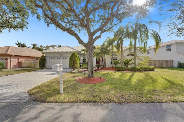 view of front of house featuring a garage and a front yard