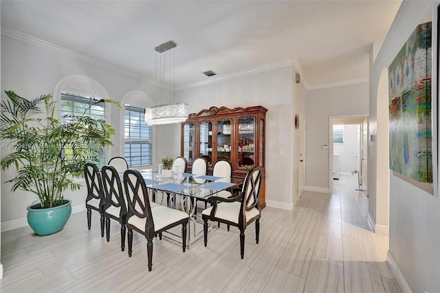 dining space with ornamental molding