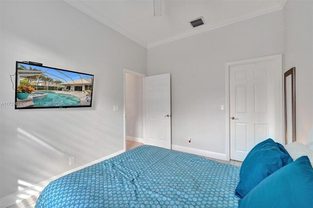 bedroom with ornamental molding and carpet flooring