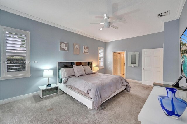 bedroom featuring multiple windows, crown molding, ceiling fan, and carpet flooring