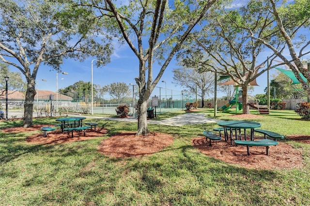 view of home's community featuring a yard and a playground