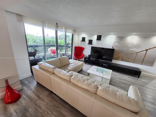 living room featuring hardwood / wood-style flooring, a textured ceiling, and floor to ceiling windows