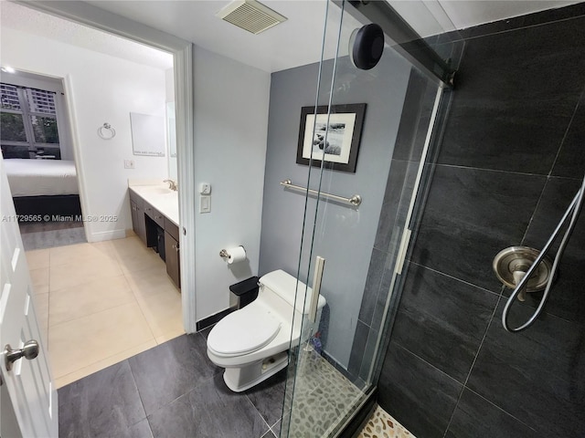 bathroom with a shower with door, tile patterned floors, toilet, and vanity