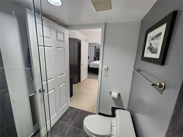 bathroom featuring toilet and tile patterned floors