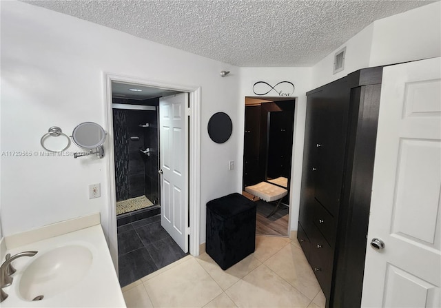 bathroom featuring sink, walk in shower, and tile patterned floors