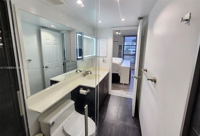 bathroom featuring vanity, toilet, and tile patterned floors