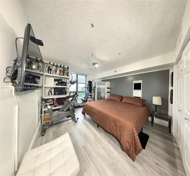 bedroom featuring a textured ceiling and light wood-type flooring