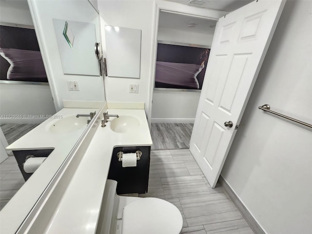 bathroom featuring toilet and vanity