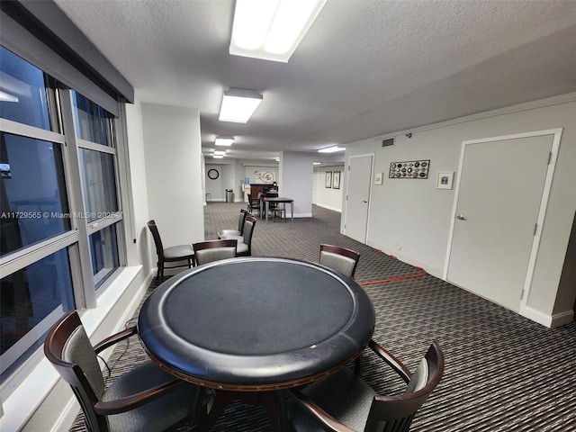 interior space with dark carpet and a textured ceiling