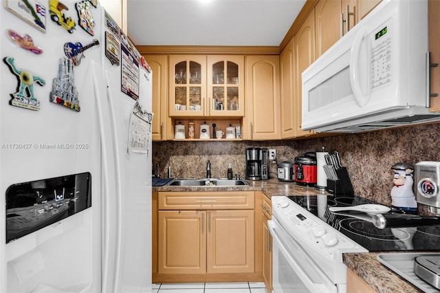 kitchen featuring sink, white appliances, decorative backsplash, and light tile patterned floors