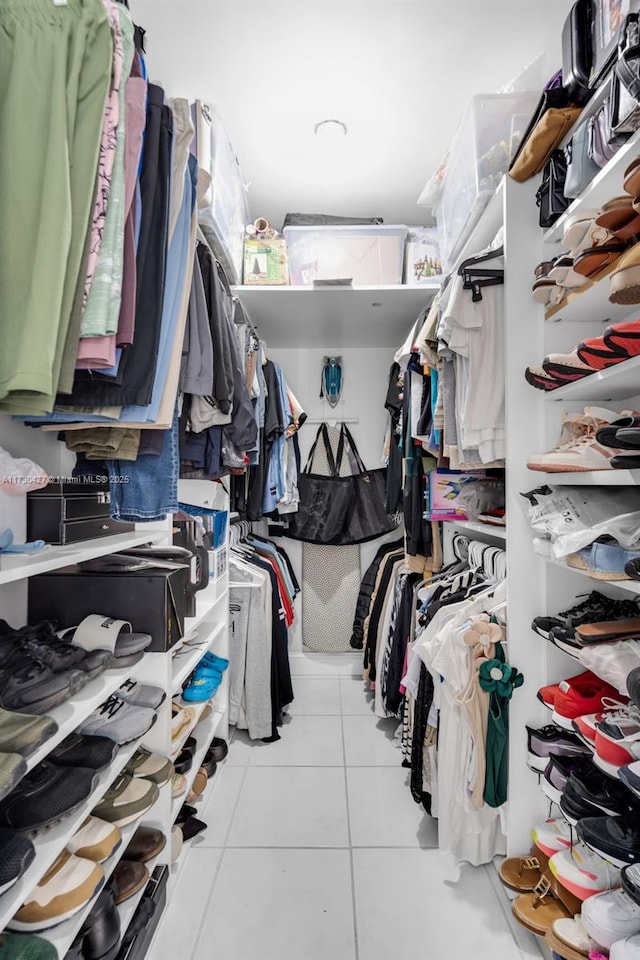 spacious closet with light tile patterned floors