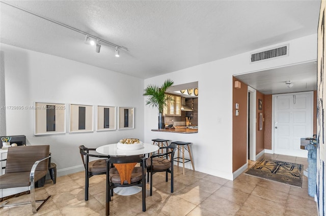 dining area featuring a textured ceiling