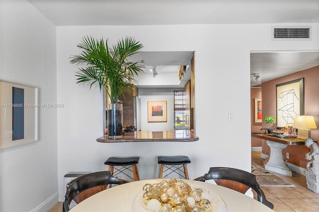 dining space featuring light tile patterned floors