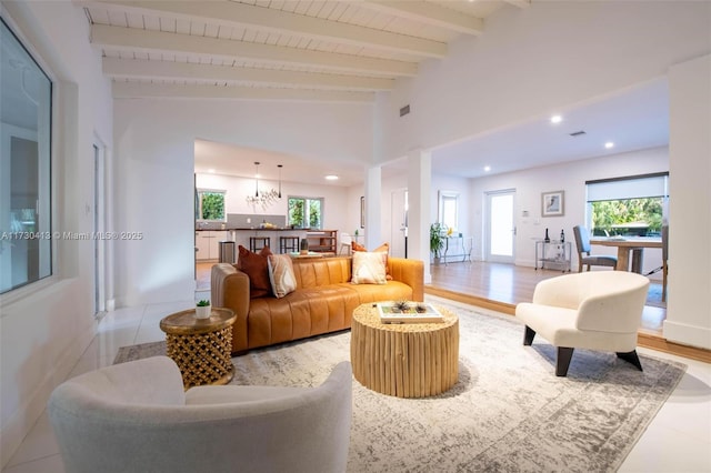 living room featuring light hardwood / wood-style floors and vaulted ceiling with beams