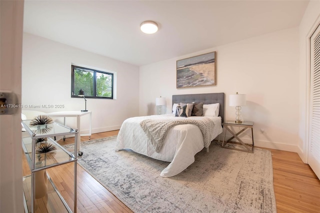 bedroom featuring hardwood / wood-style floors and a closet